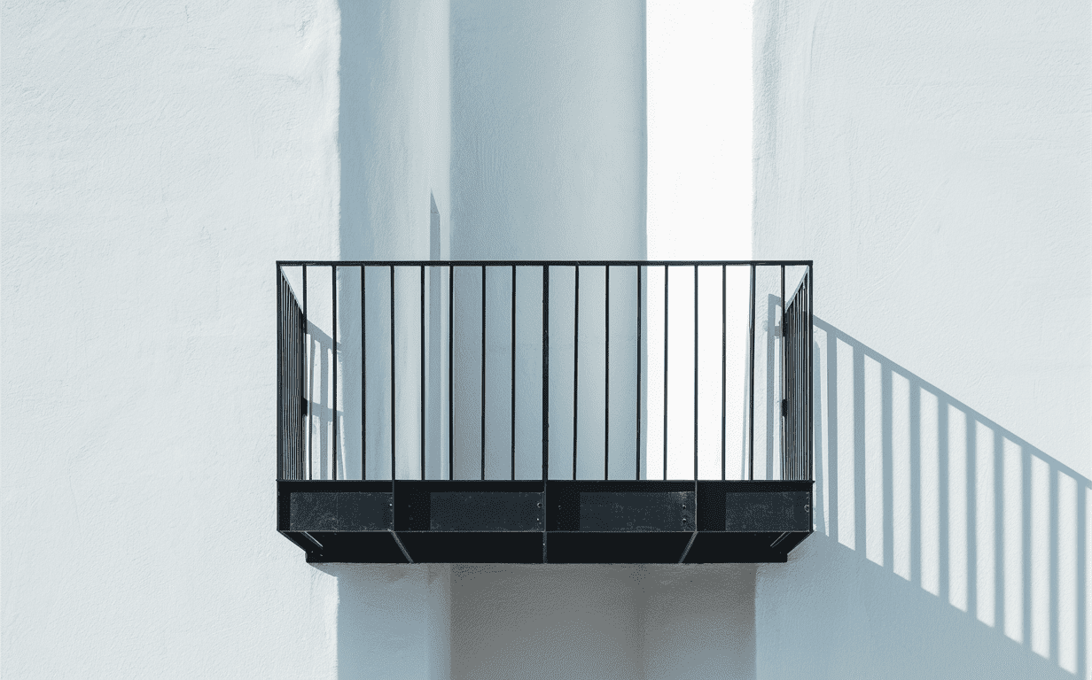 Balcony with a metal railing and a wooden floor.
